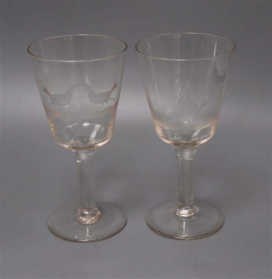 A pair of wheel engraved glass goblets height 20cm